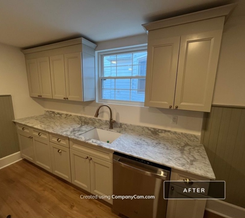After kitchen remodel in Bucks County PA with new cabinets, marble countertops, updated flooring, and modern finishes by RPK Construction